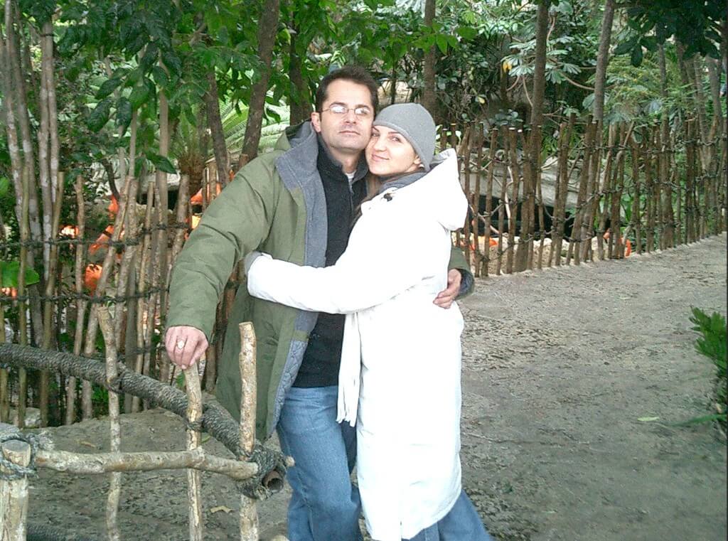 Scott and Mila embracing at a flamingo enclosure