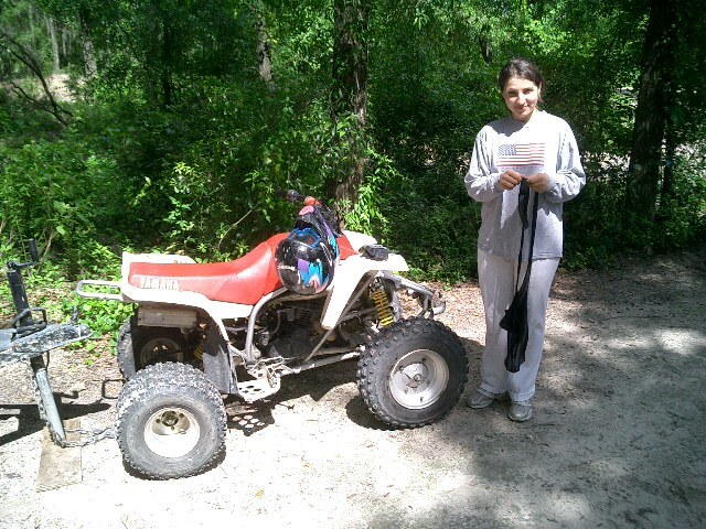 Mila with a Yamaha ATV on a wooded trail