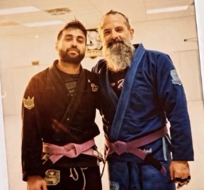 Scott and a teammate in purple belts on promotion day