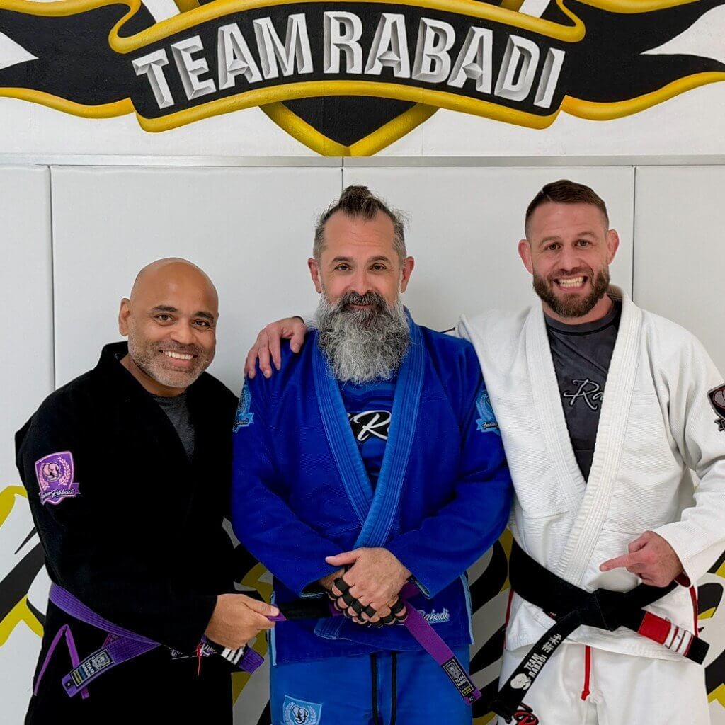 Scott with two teammates at Team Rabadi on purple belt day
